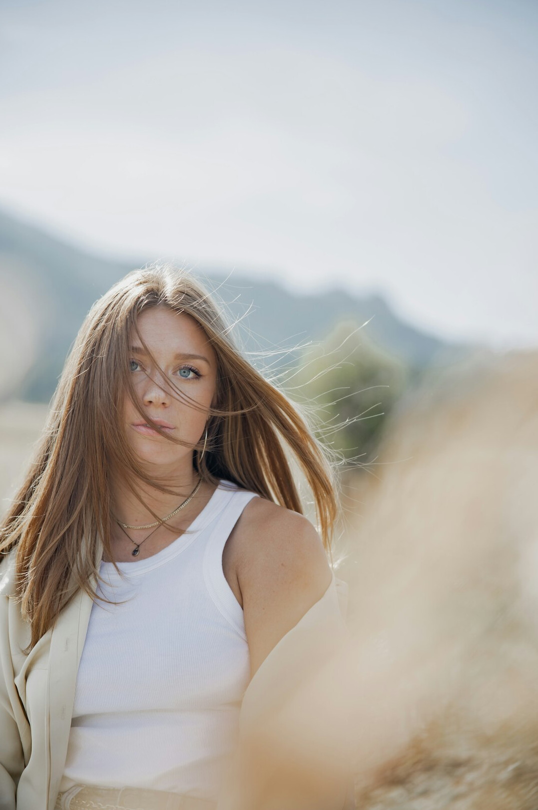 Portrait of a smiling woman with long hair outdoors