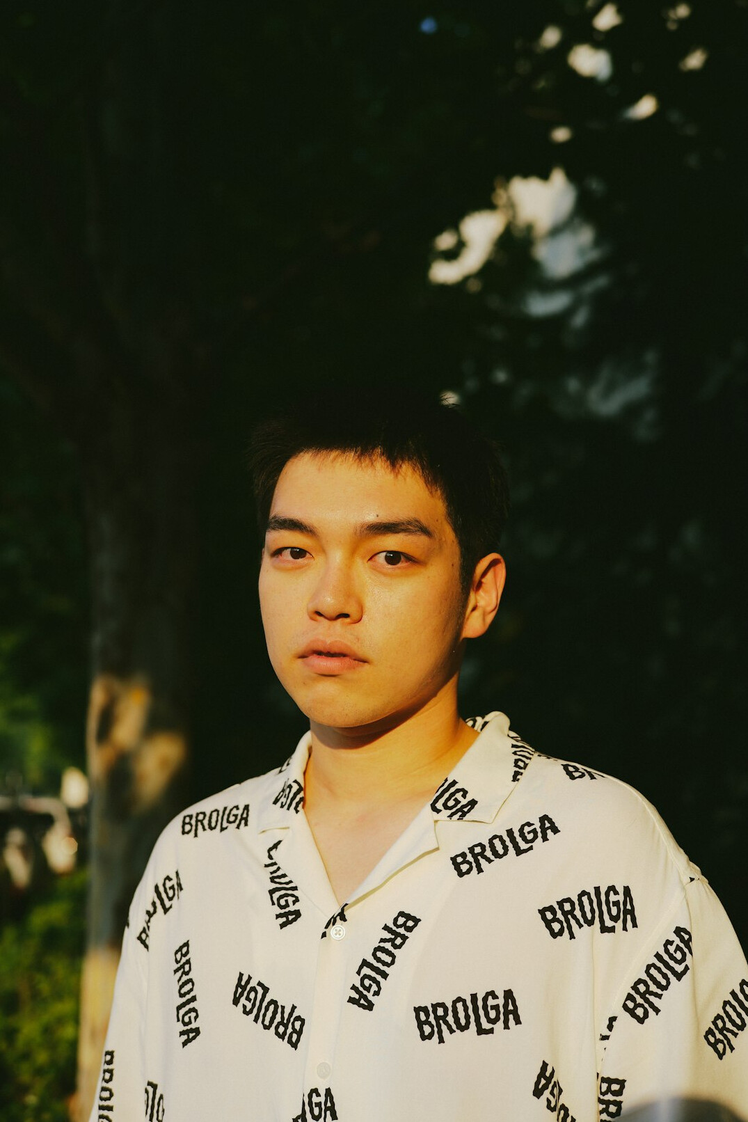 Portrait of a man with short dark hair and a light shirt