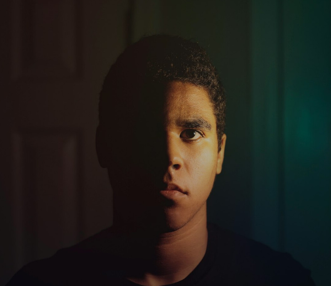 Portrait of a young man in a shirt looking at the camera